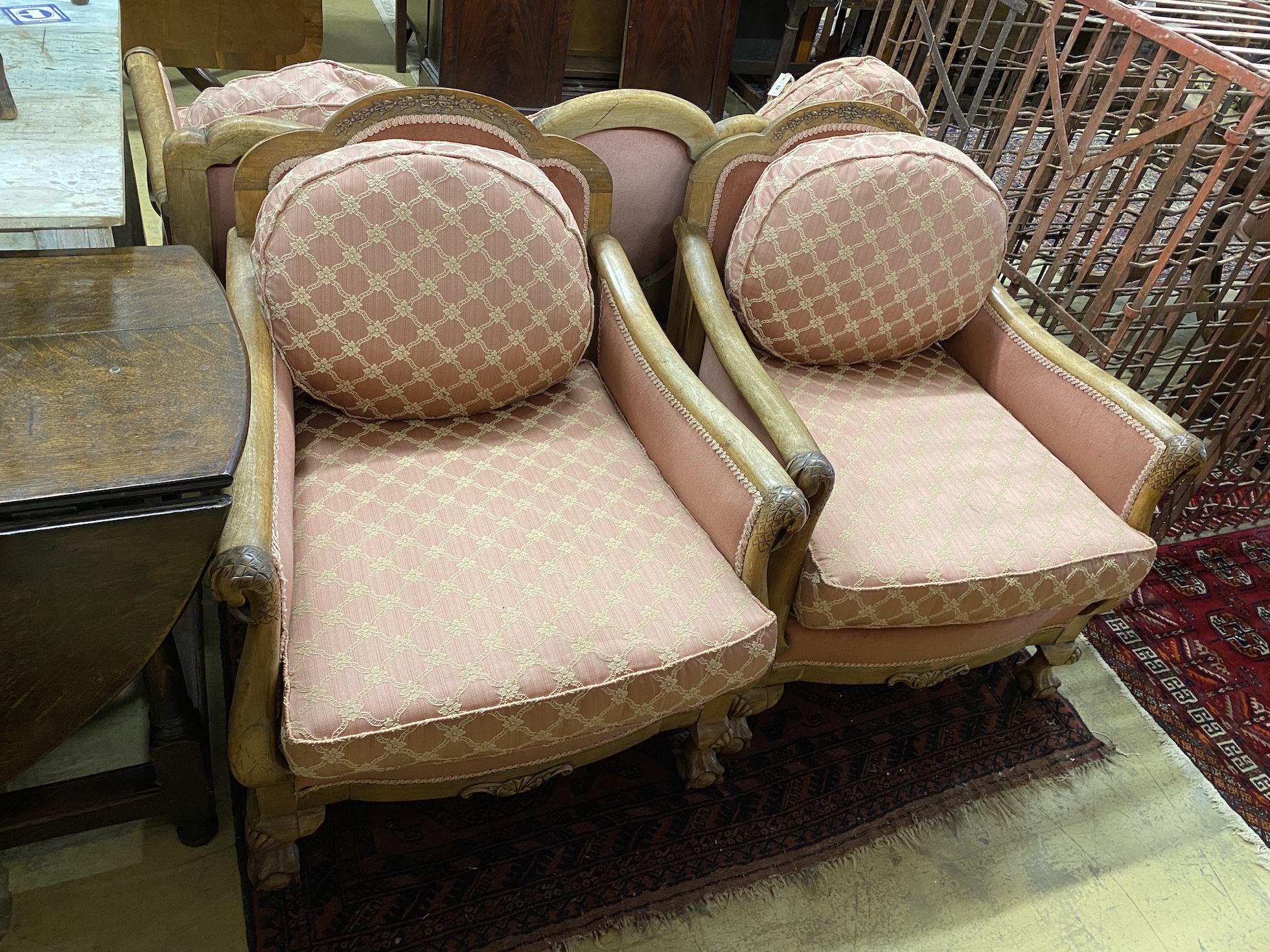 An early 20th century faded mahogany three piece suite, settee length 163cm, depth 85cm, height 80cm